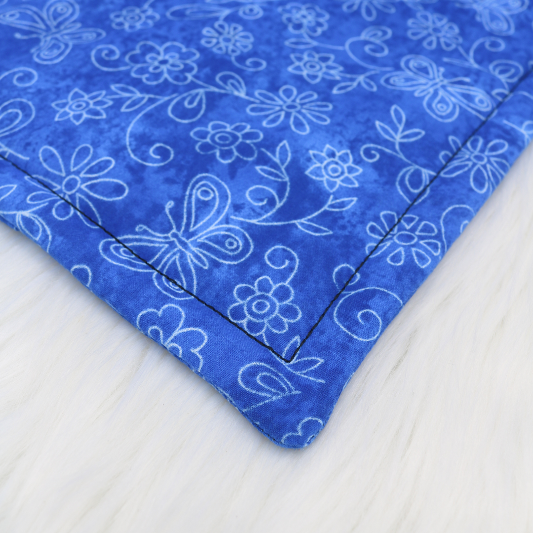 The Luminous Pets Refillable Catnip Mat with Flowers and butterflies on blue | Comes with to refillable pouches of catnip and valerian root